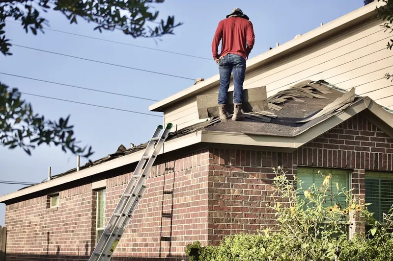 Professional roofer working on a residential roof in Washington Avenue - Memorial Park